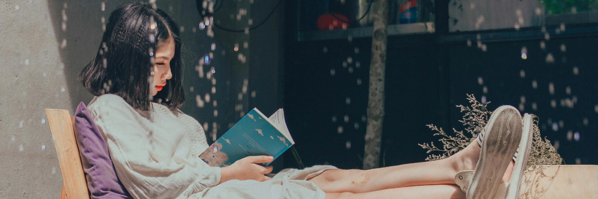 Adult Reading on Chair with Feet Up