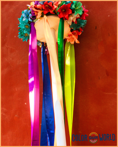 image of a crown of flowers and colorful ribbons hanging down