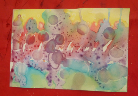 Bright splashes of watercolor paint framed in red