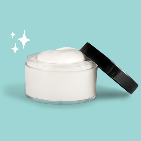 A clear jar of white cream with a black lid slightly ajar.