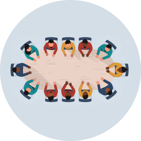 A group of people seated around a large oval table, viewed from above.