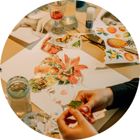 Hands arranging a colorful collage