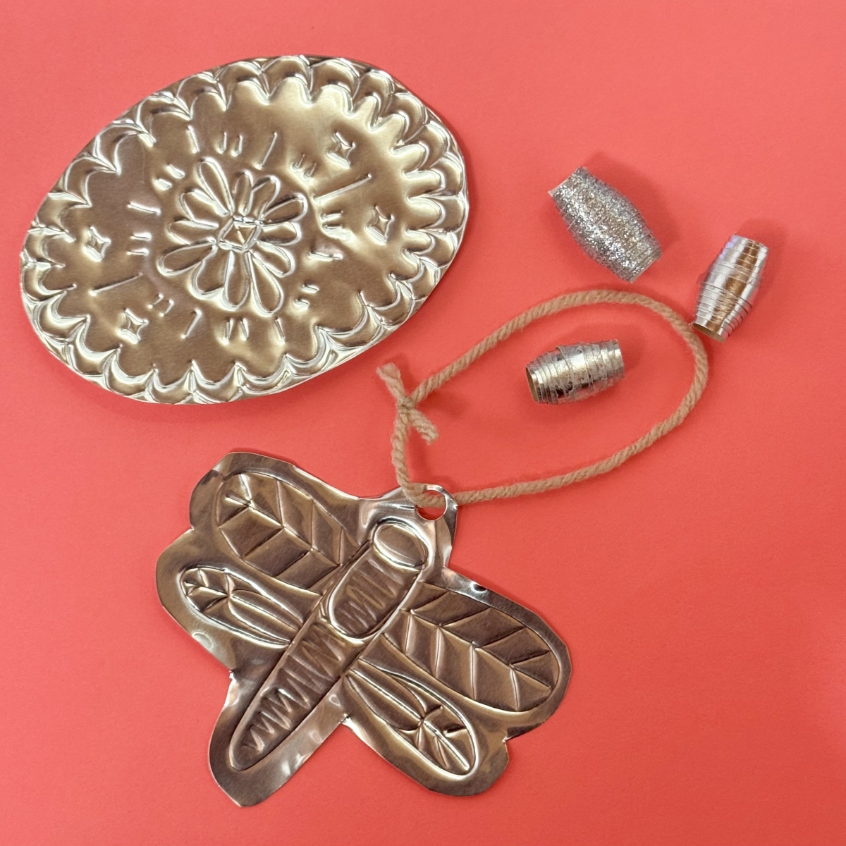 tinwork image of a dragonfly and a medallion 