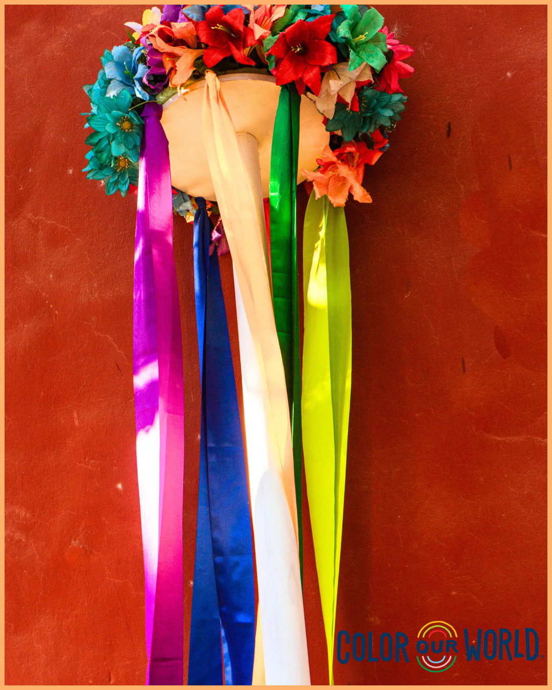 image of a crown of flowers and colorful ribbons hanging down