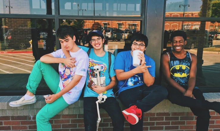 4 Teens sitting outside