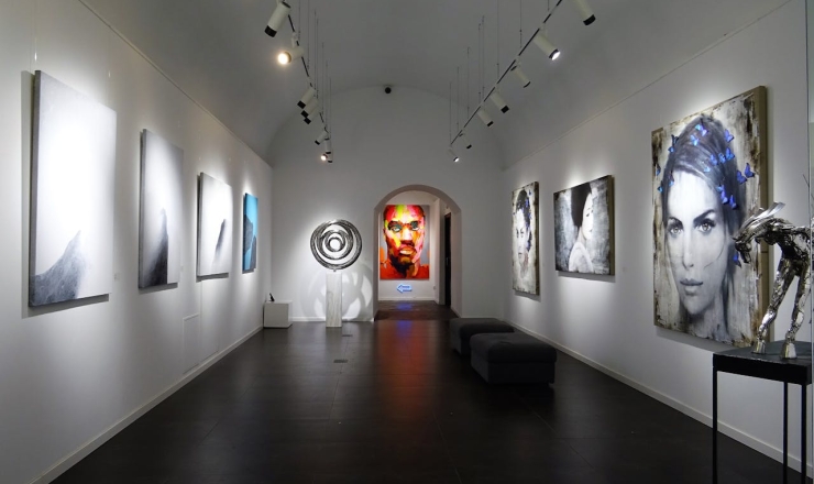 Art gallery with paintings on white walls